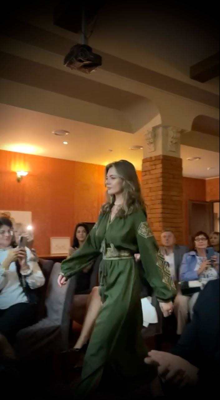 A finalist walks the runway in national dress by Vyshyte