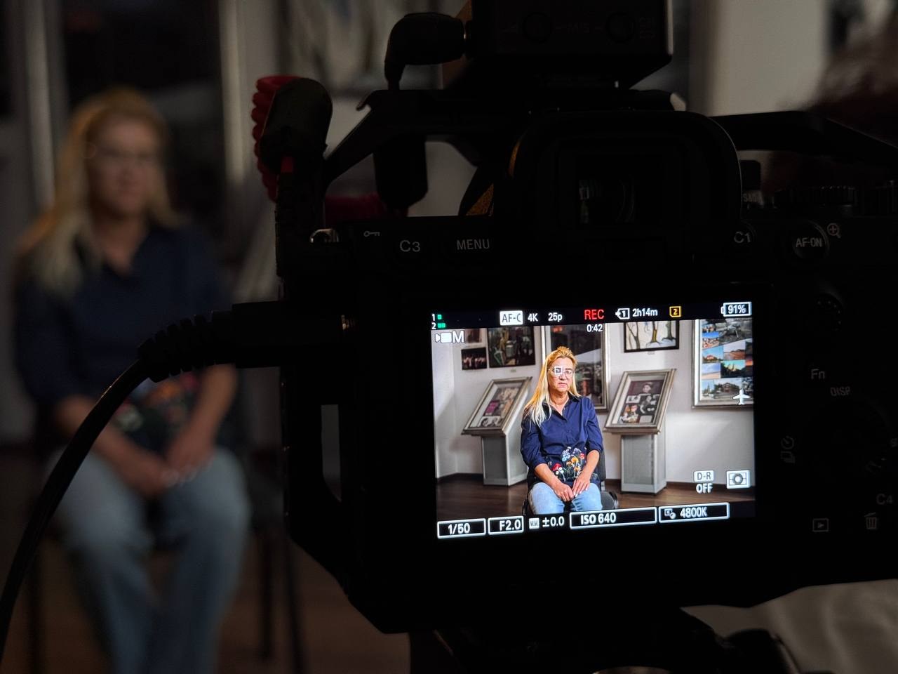 Maksym Tuzhylin filming an interview on set